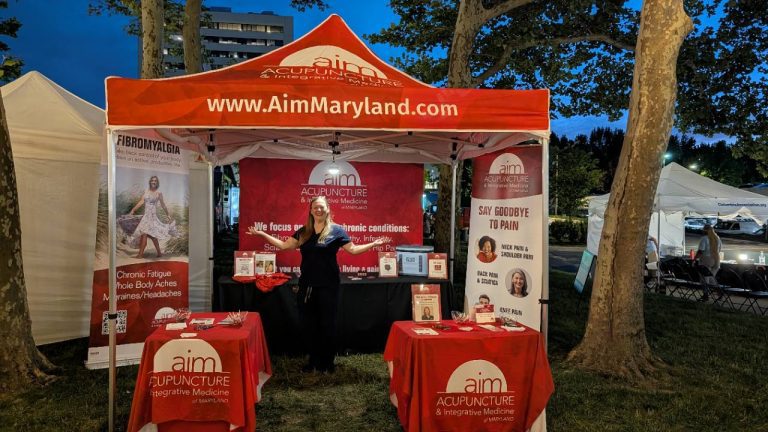 AIM Maryland acupuncture and integrative medicine booth at a Columbia community event