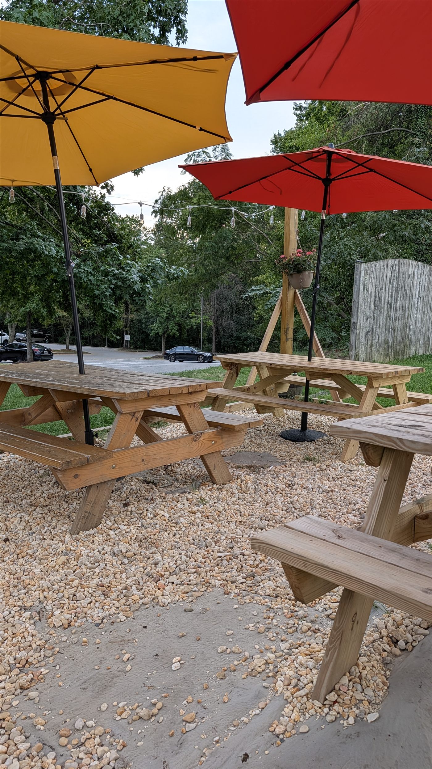 Picnic tables and umbrellas at DMV Taqueria outdoor seating in Columbia, Maryland