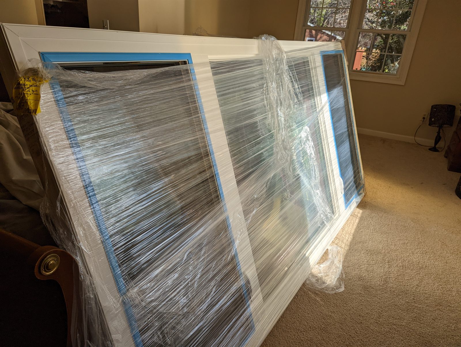 Wrapped Vytex replacement windows waiting inside a Columbia Maryland home before installation
