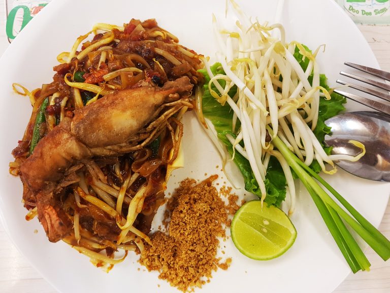 Plate of Pad Thai with lime, egg, bean sprouts, and peanuts